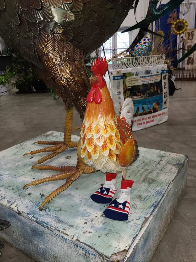 A rooster sculpture wearing flag socks