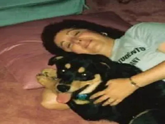Lorraine lying on the bed, hugging Woodrow